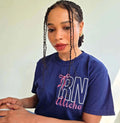 Person wearing a blue shirt with 'RN Alisha' printed on it, sitting at a desk.custom-nurse-shirt