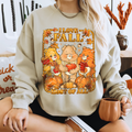 Person wearing a sweatshirt with 'I love Fall most of all' design featuring bears and pumpkins. cozy-fall-bear-sweatshirt