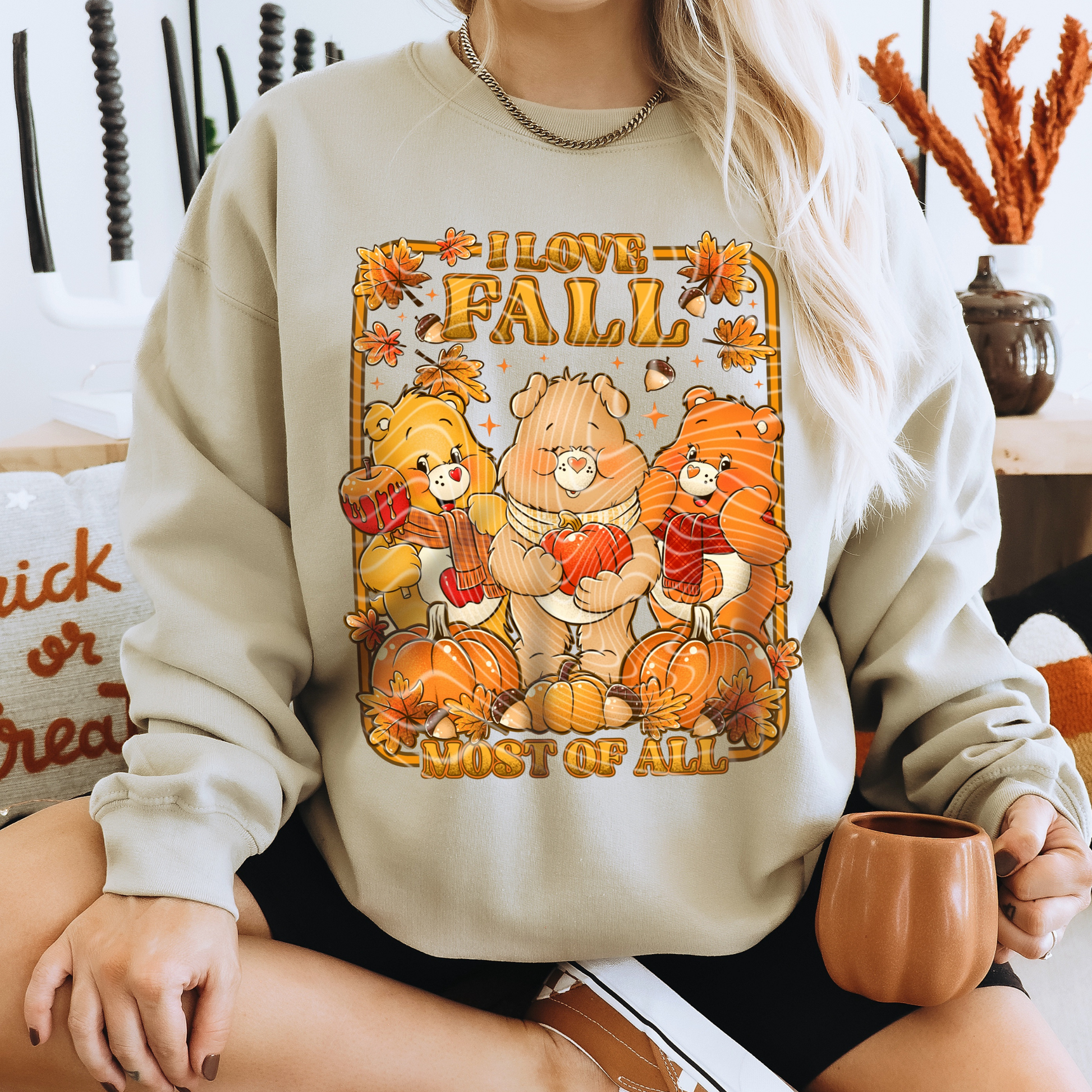 Person wearing a sweatshirt with 'I love Fall most of all' design featuring bears and pumpkins. cozy-fall-bear-sweatshirt
