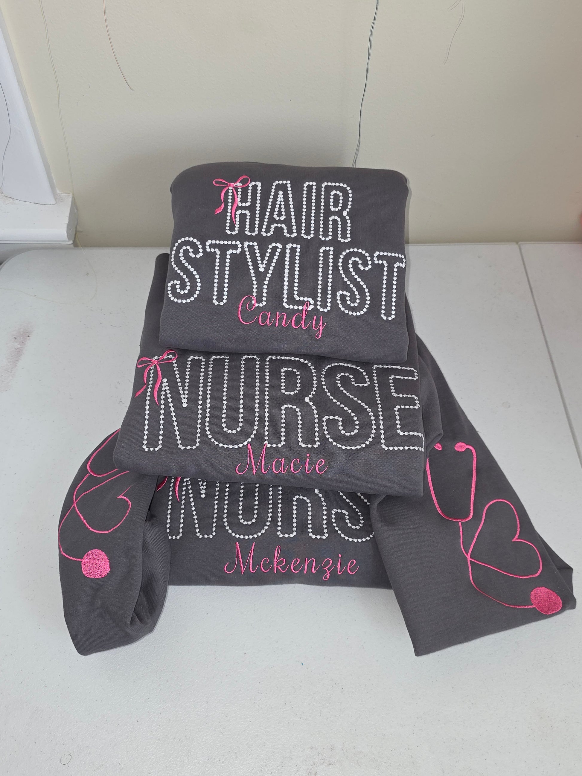 Gray headband with 'Hair Stylist', 'Nurse', and 'Makeup Artist' text on a white background