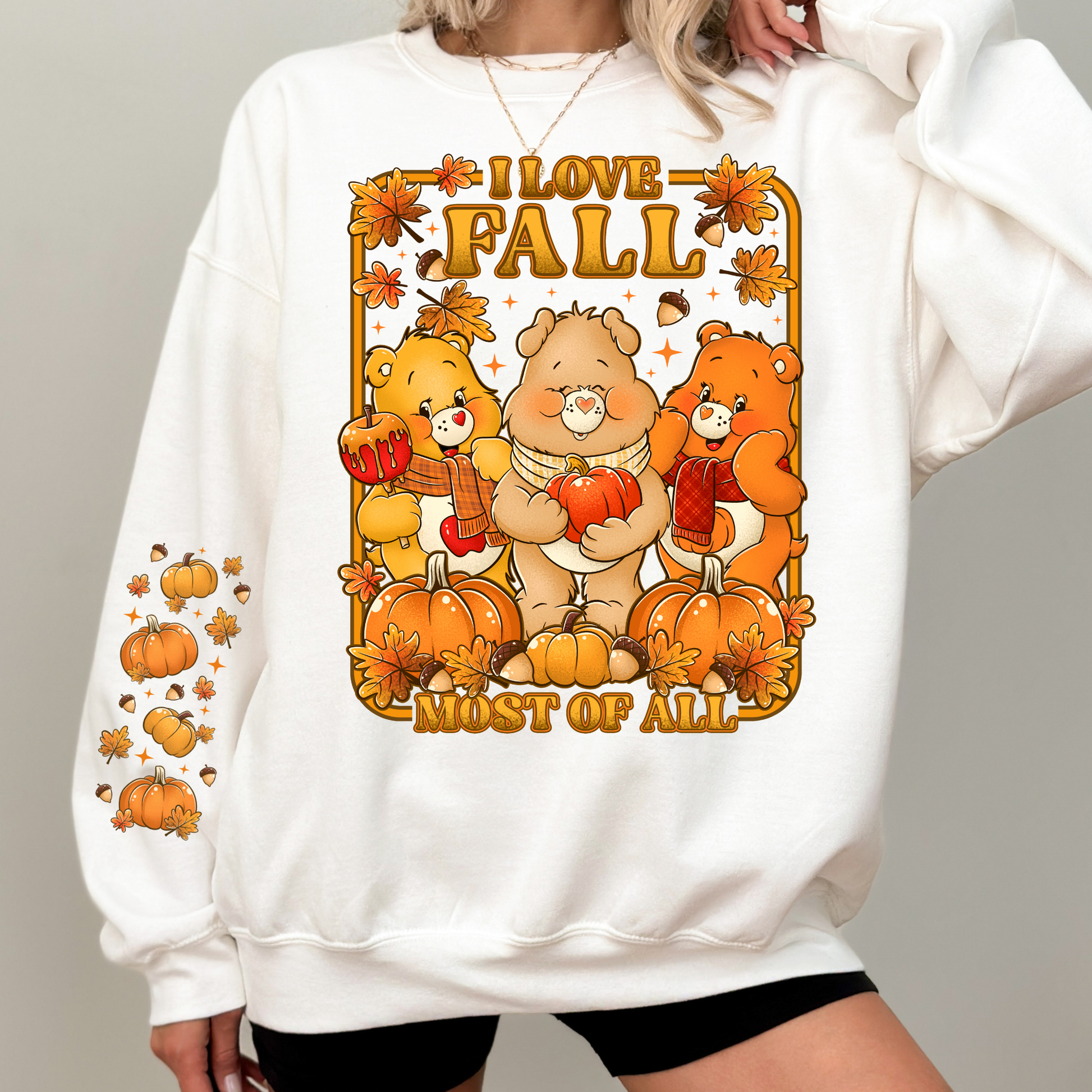 White sweatshirt with 'I Love Fall Most of All' graphic featuring cartoon bears and pumpkins. cozy-fall-bear-sweatshirt
