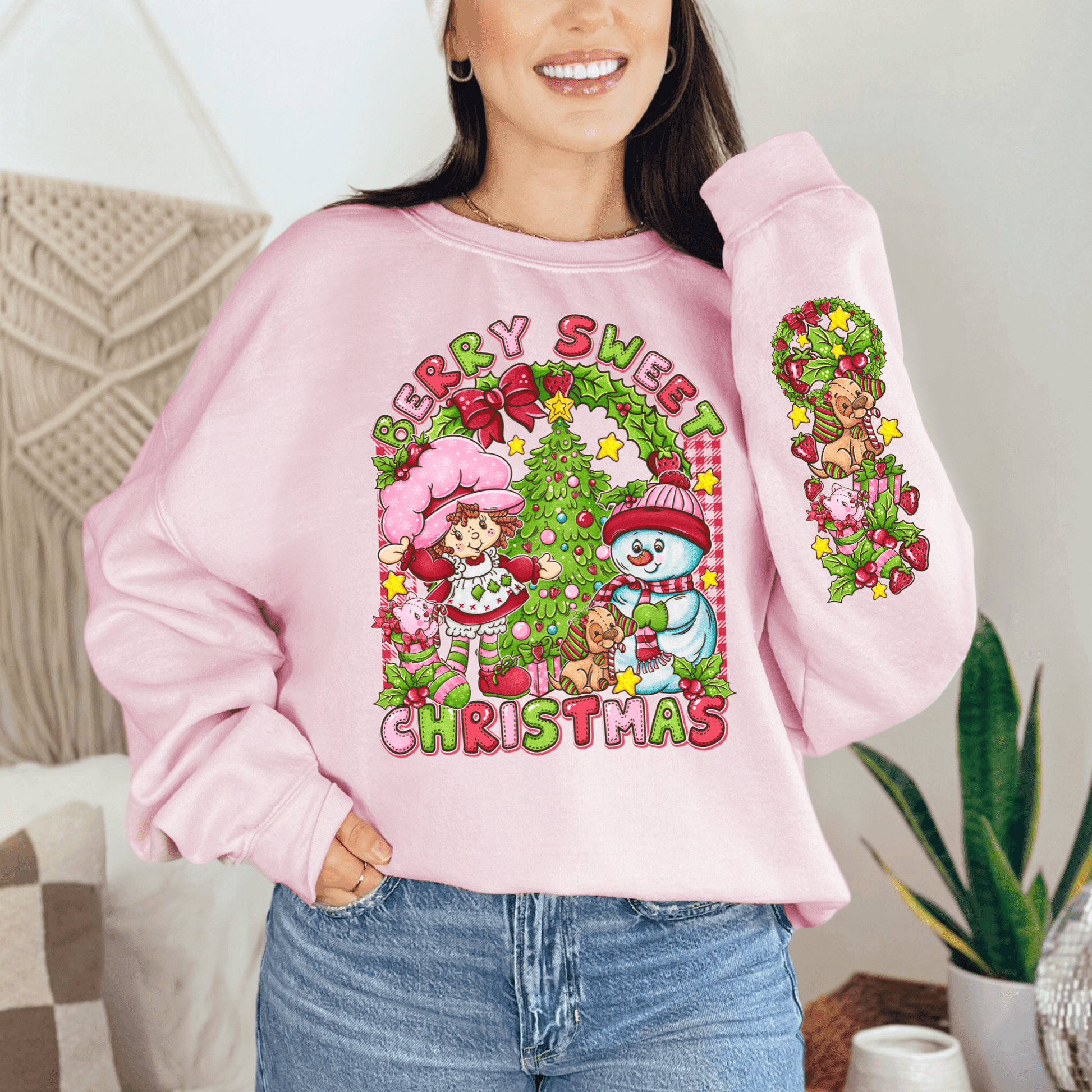 Person wearing a pink Christmas-themed sweatshirt with festive graphics.
