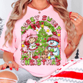Person wearing a pink Christmas-themed t-shirt with cartoon characters and text.