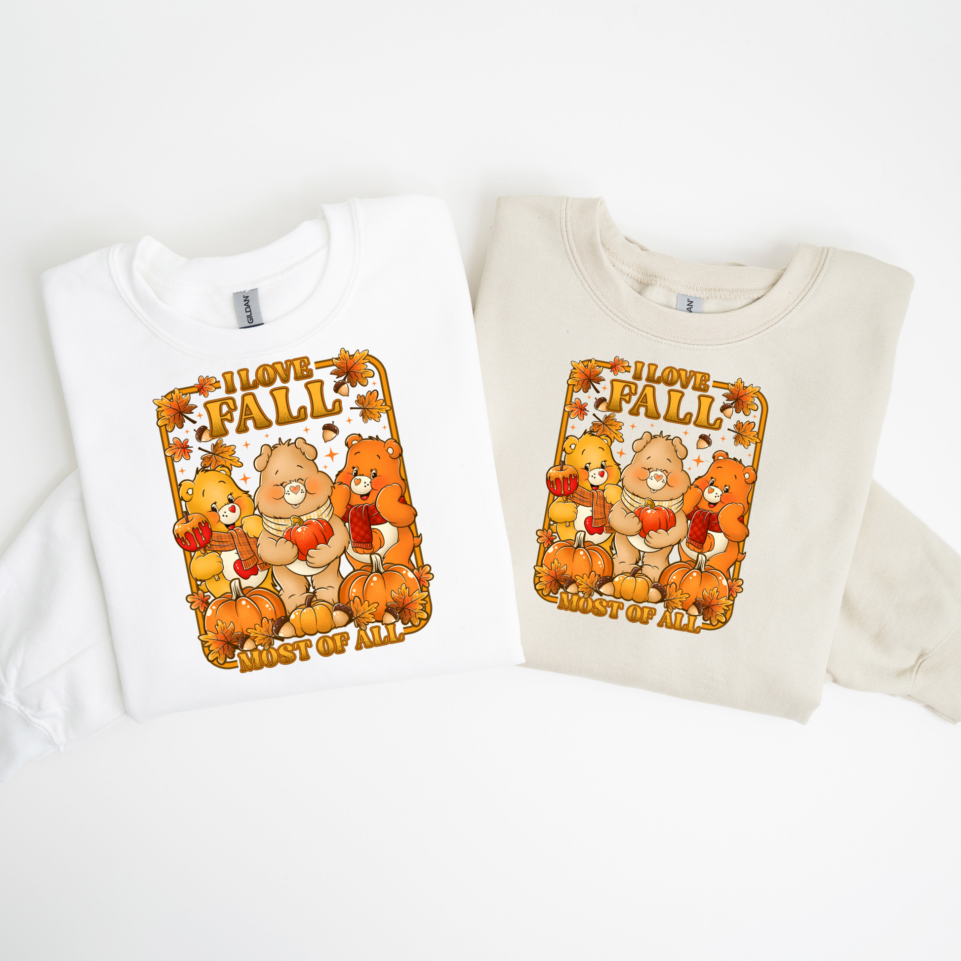 Two folded sweatshirts with 'I love fall' graphic design featuring bears and pumpkins on a white background.  cozy-fall-bear-sweatshirt