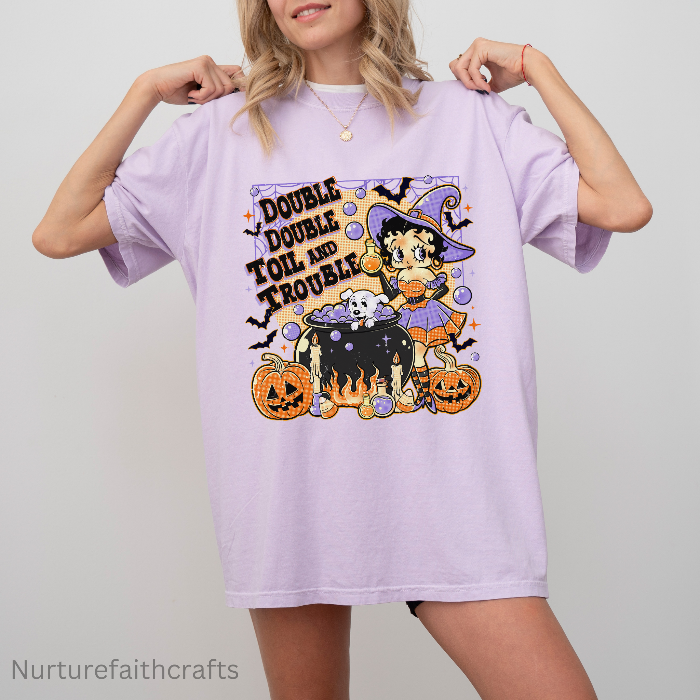 Person wearing a purple t-shirt with a Halloween-themed design featuring a witch and text. vintage-witch-halloween-tee
