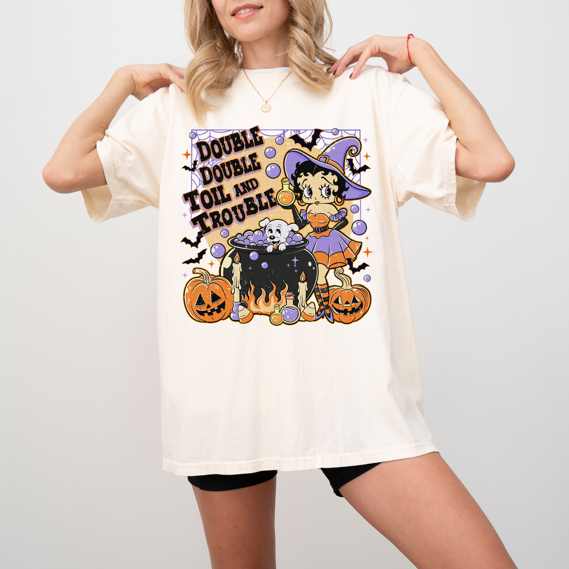 Person wearing a Halloween-themed t-shirt with cartoon character and text.vintage-witch-halloween-tee