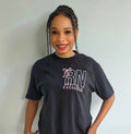 Person wearing a black t-shirt with 'RN' and 'Alitica' text on a plain background.custom-nurse-shirt