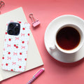 Phone case with cherry pattern on pink surface with coffee cup and stationery.coquette-phone-case