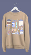 a sweatshirt with hand-drawn medical doodles including a stethoscope, syringe, band-aids, and a steaming cup of coffee.