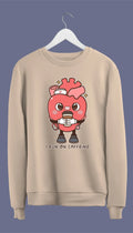 A  crewneck sweatshirt with a graphic of an anatomical heart holding a coffee cup and the phrase 'I live on caffeine.'.