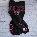 Black sweatshirt with embroidered pink text spelling 'NURSE' and a heart-shaped bow design underneath.